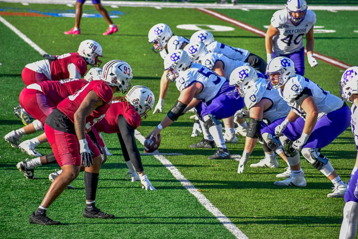 The football defensive line prepares for a Holy Cross snap in Saturday's loss. (Photo by Emma Sylvester '25)