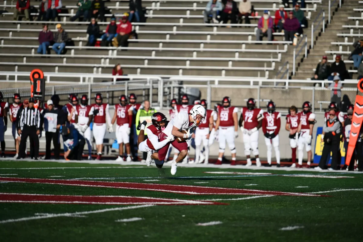 Junior wide receiver Elijah Steward gets tackled by a Colgate University defender. (Photo by Shea Widerman for GoLeopards)
