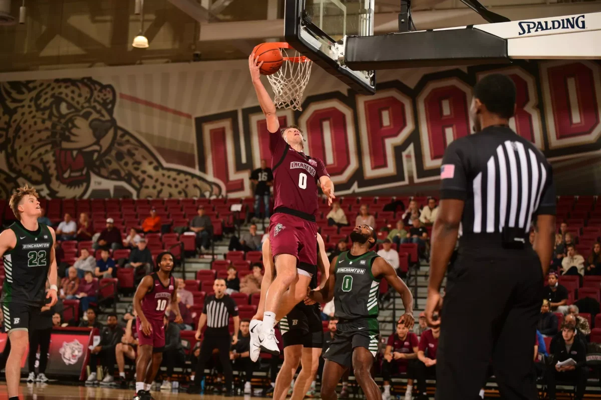 Junior guard Ryan Pettit lays the ball up after a steal against Binghamton University on Sunday. (Photo by Hannah Ally for GoLeopards)