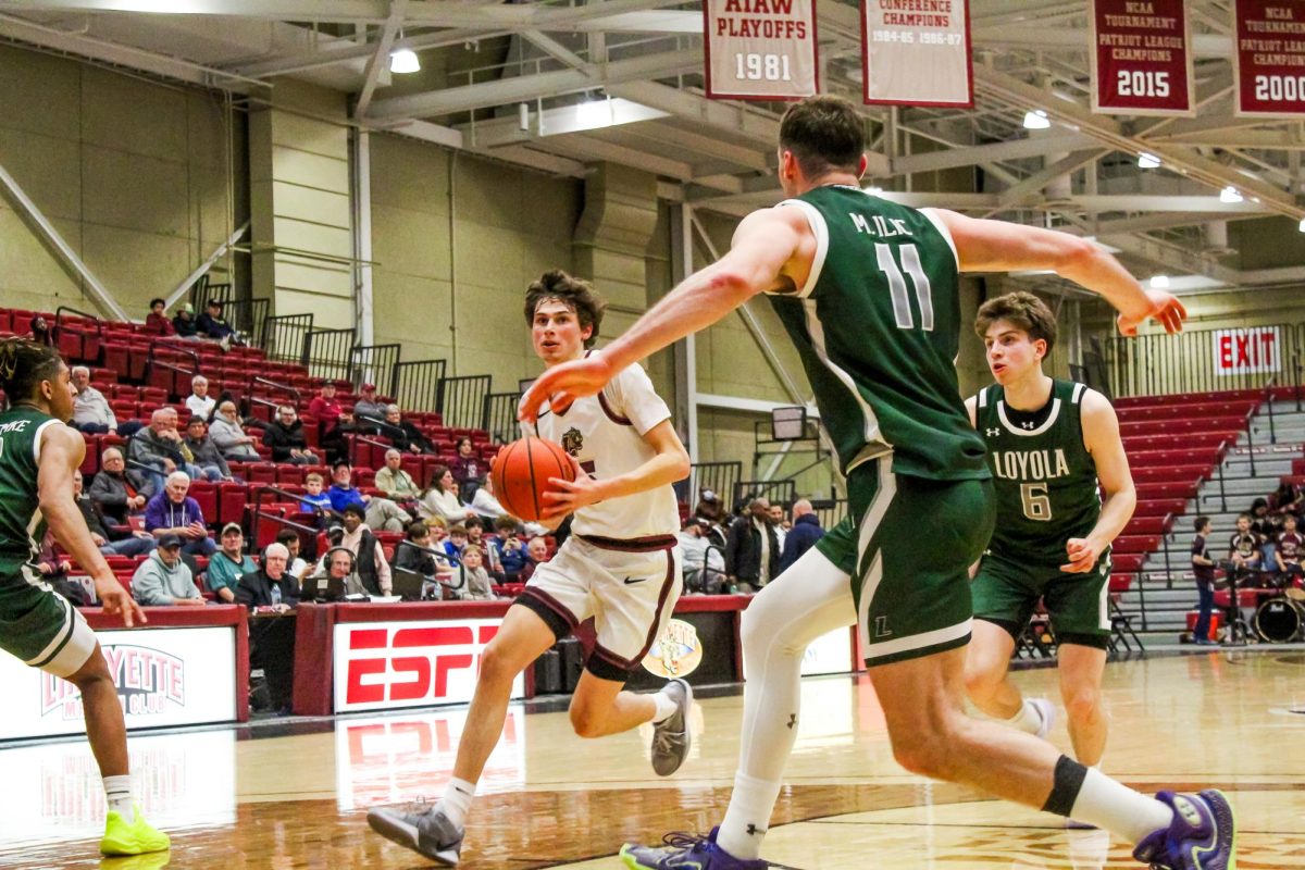 Freshman guard Alex Chaikin drives inside against Loyola Maryland University on Wednesday.