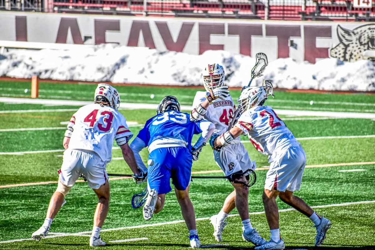 Three members of the men's lacrosse team surround an Air Force player in the Leopards' season-opening Saturday victory. 