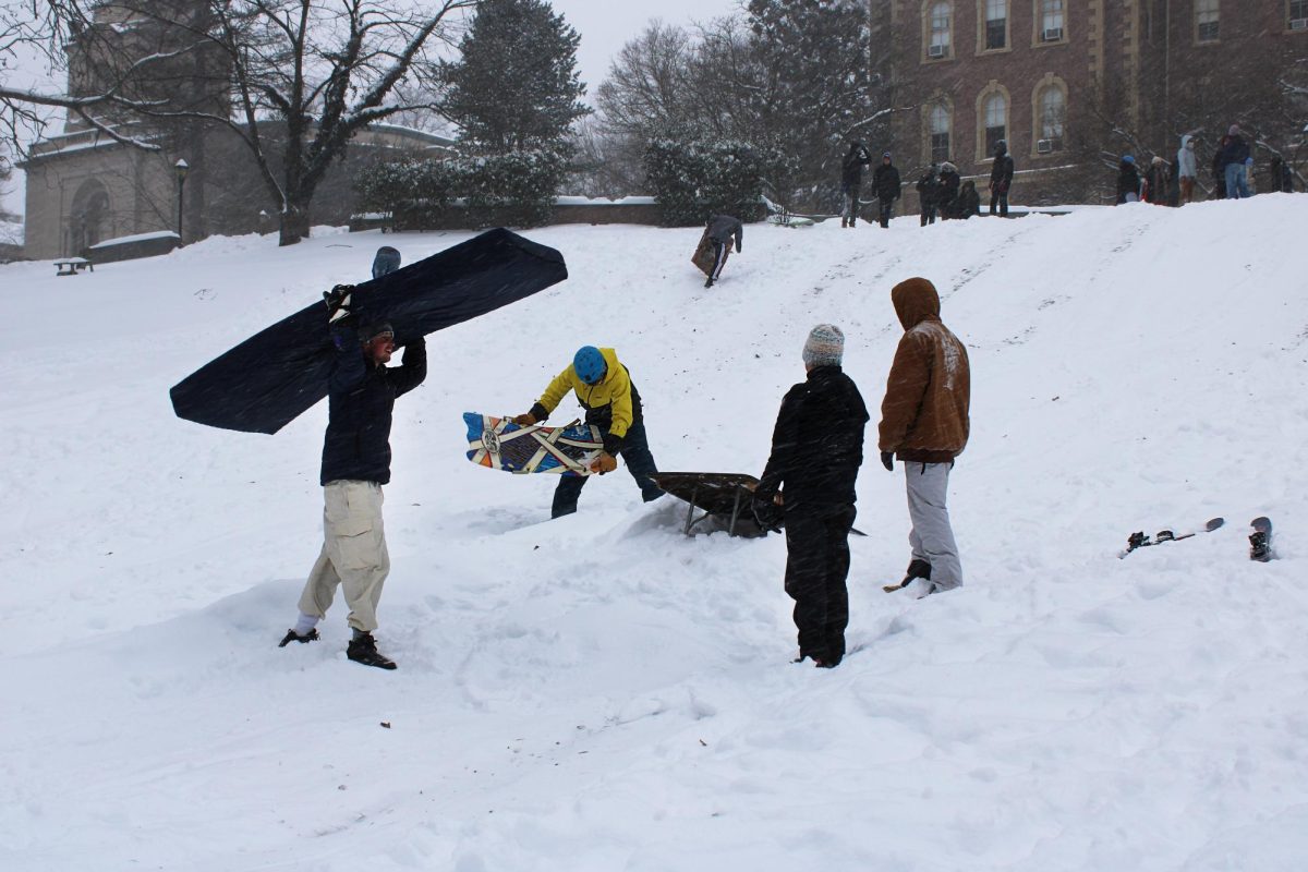 Members of the college ski club used a folding table and a residence hall mattress to create a makeshift ski jump.