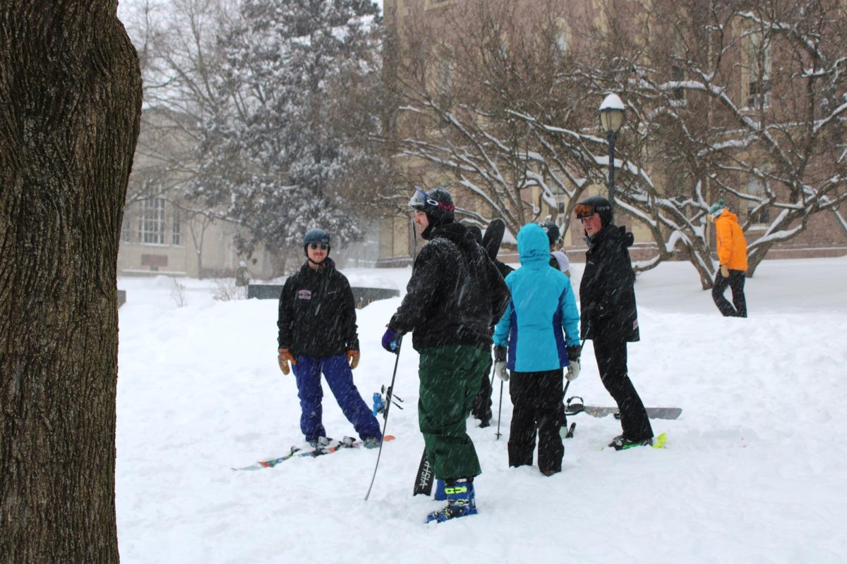 Students mingle as they wait their turn to ski down the hill behind Pardee Hall.
