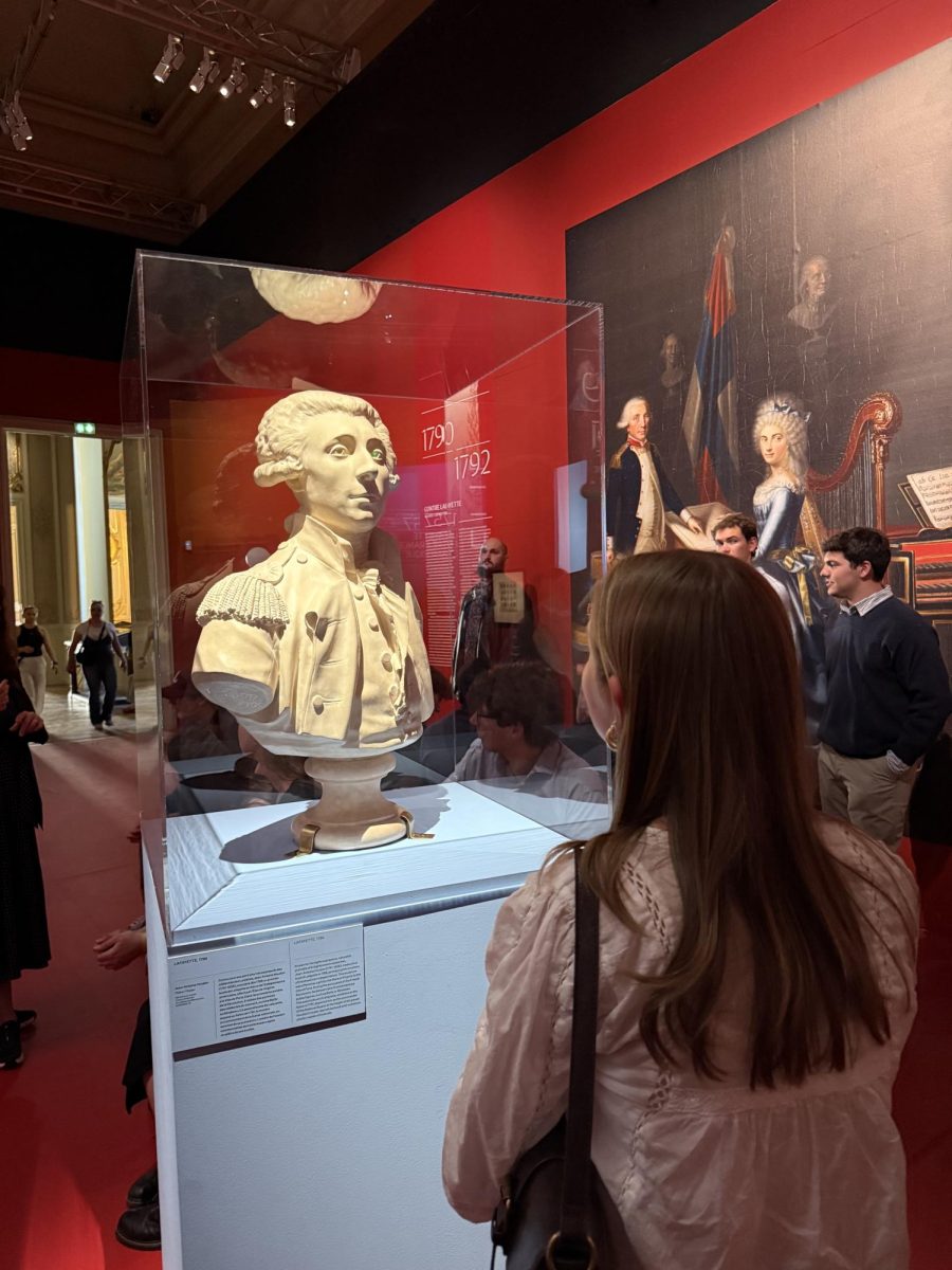 A Lafayette College student studying abroad views a bust of her college's namesake.